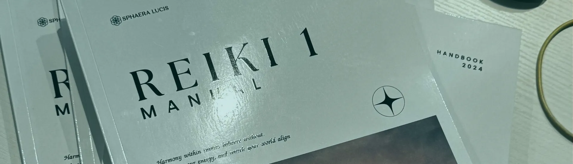 Printed Sphaera Lucis Reiki 1 manuals on a table